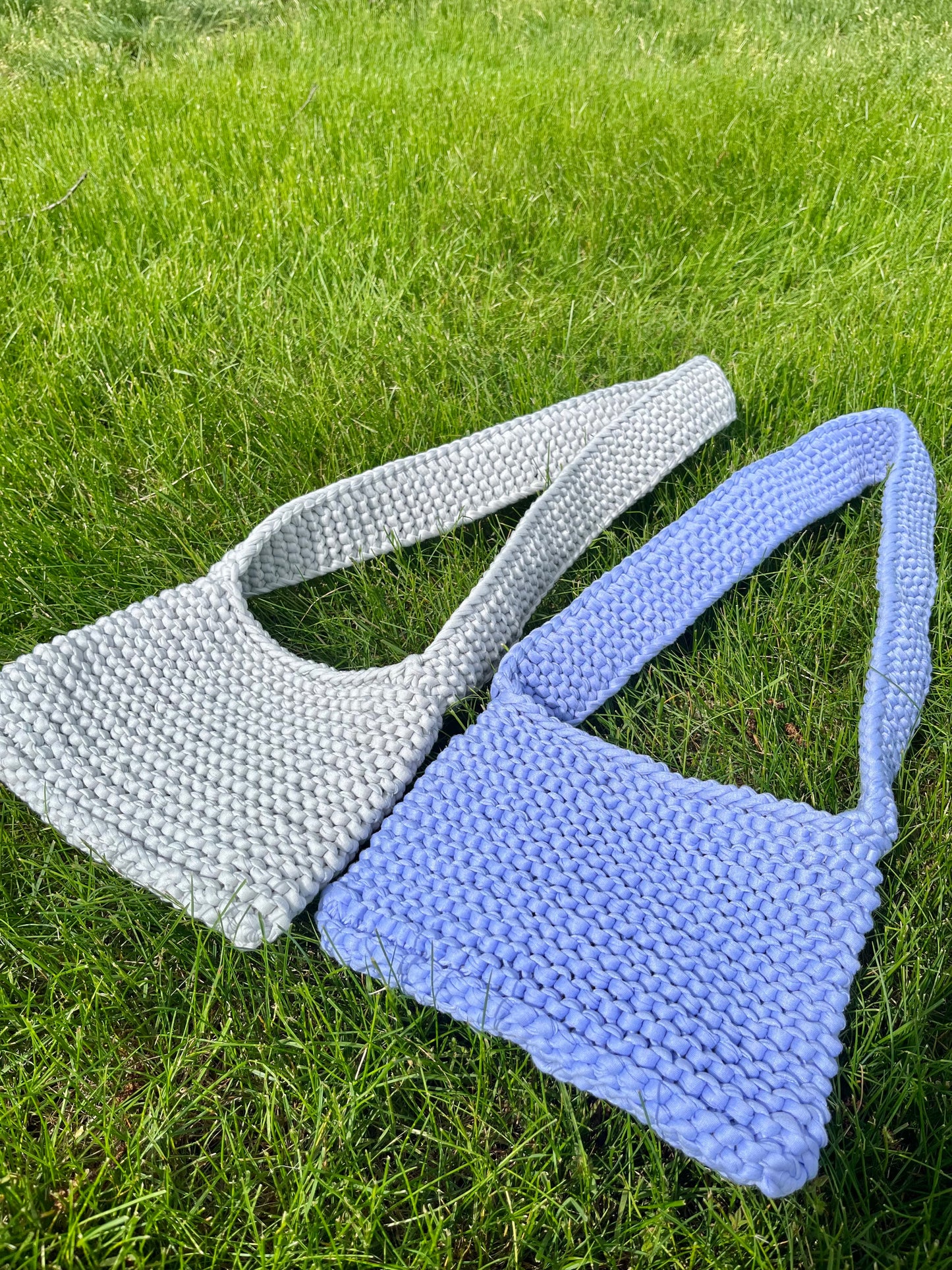 hand knit tote bags on grass